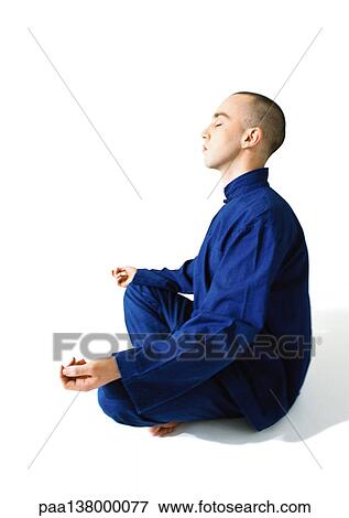 Man sitting in lotus position, meditating, side view View Large Photo Image Stock Photo - Man sitting in lotus position, meditating, side view. Fotosearch