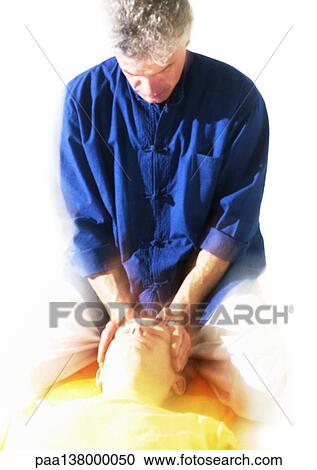 Massage therapist massaging man's head View Large Photo Image Stock Image - Massage therapist massaging man's head. Fotosearch