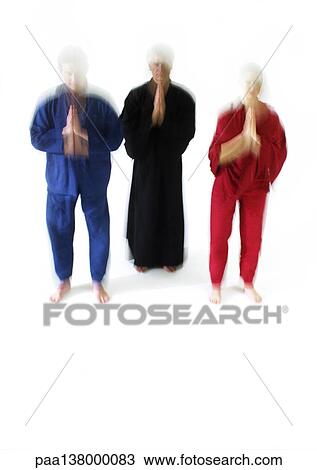 Three people standing with hands together and eyes closed, blurred View Large Photo Image Stock Image - Three people standing with hands together and eyes closed, blurred. Fotosearch