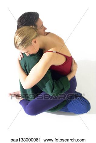 Woman and man with arms around each other, woman sitting on man's lap, high angle view View Large Photo Image Stock Image - Woman and man with arms around each other, woman sitting on man's lap, high angle view. Fotosearch
