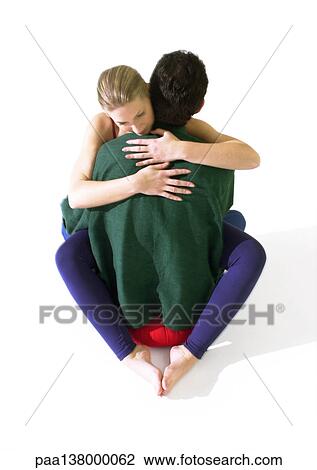 Woman and man with arms around each other, woman sitting on man's lap View Large Photo Image Stock Image - Woman and man with arms around each other, woman sitting on man's lap. Fotosearch