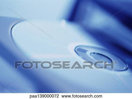 Stock Image - CD-ROM drive holding CD, close-up.. Fotosearch