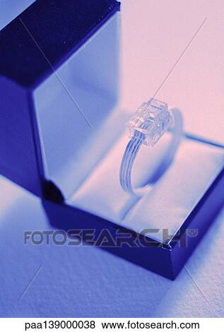 Stock Photo - Computer plug presented as ring in giftbox, close-up.. Fotosearch
