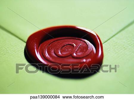 Picture - Envelope with commercial-at "@" symbol on wax seal, focus on symbol.. Fotosearch