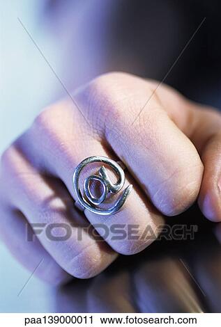 Hand wearing "@" ring, close-up. View Large Photo Image Stock Image - Hand wearing "@" ring, close-up.. Fotosearch