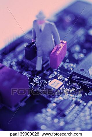 Stock Photo - Smal ltoy figure on computer circuit board, close-up.. Fotosearch
