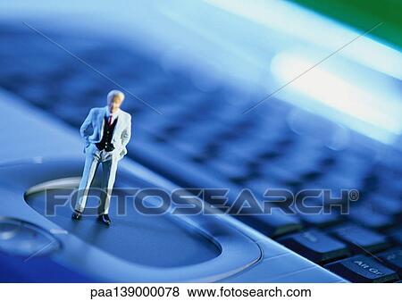 Small toy figure on computer keyboard, focus on figure, close-up. View Large Photo Image Stock Photo - Small toy figure on computer keyboard, focus on figure, close-up.. Fotosearch