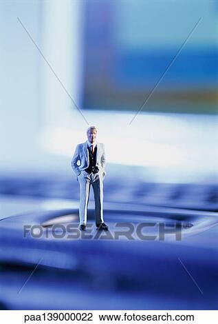 Small toy figure standing on computer keyboard, focus on figure. View Large Photo Image Stock Image - Small toy figure standing on computer keyboard, focus on figure.. Fotosearch