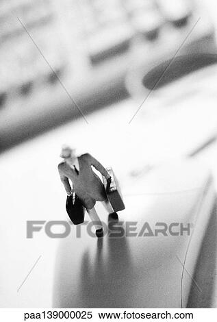Small toy figure standing on computer mouse, b&w. View Large Photo Image Stock Photography - Small toy figure standing on computer mouse, b&w.. Fotosearch