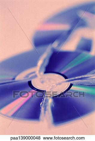 Stock Photo - Two broken CD's, blurred.. Fotosearch