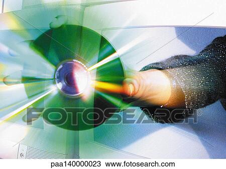 Drawing - Hand holding CD emerging from computer monitor, digital composite.. Fotosearch