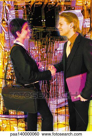 Clipart - Young business couple shaking hands, side view, digital composite.. Fotosearch