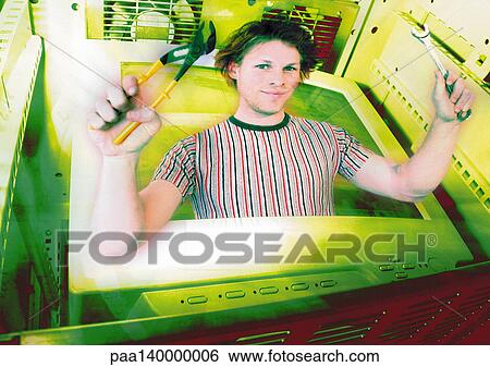 Stock Illustration - Young man emerging from computer monitor, holding work tools, digital composite.. Fotosearch