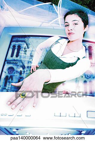 Stock Illustration - Young woman emerging from computer monitor, showing ring on finger, digital composite.. Fotosearch