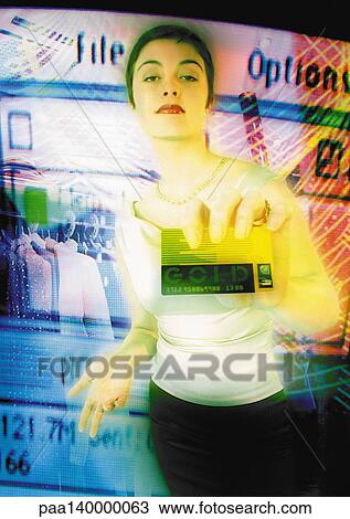 Young woman holding credit card toward camera, digital composite. View Large Illustration Drawing - Young woman holding credit card toward camera, digital composite.. Fotosearch