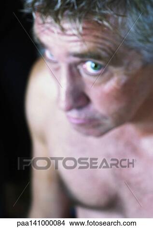 Mature man looking into camera, blurred, high angle view. View Large Photo Image Picture - Mature man looking into camera, blurred, high angle view.. Fotosearch