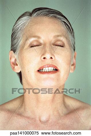 Stock Photography - Mature woman, eyes closed, lips parted, portrait.. Fotosearch