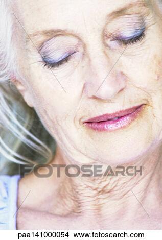 Picture - Mature woman, smiling, eyes closed, portrait.. Fotosearch