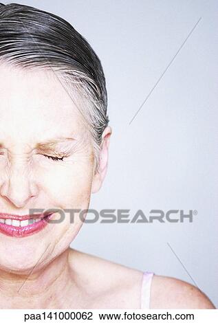 Mature woman smiling, eyes closed, portrait. View Large Photo Image Stock Image - Mature woman smiling, eyes closed, portrait.. Fotosearch