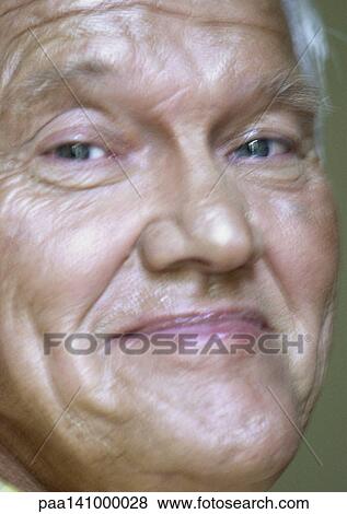 Stock Photo - Senior man looking into camera, close-up.. Fotosearch
