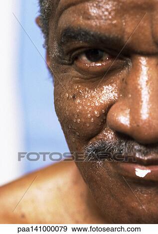 Senior man with wet face looking into camera, close-up of one side of face. View Large Photo Image Stock Photo - Senior man with wet face looking into camera, close-up of one side of face.. Fotosearch