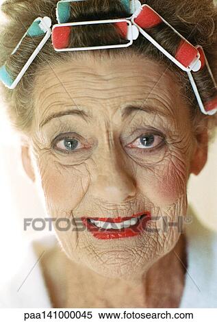 Stock Photography - Senior woman looking into camera, portrait.. Fotosearch