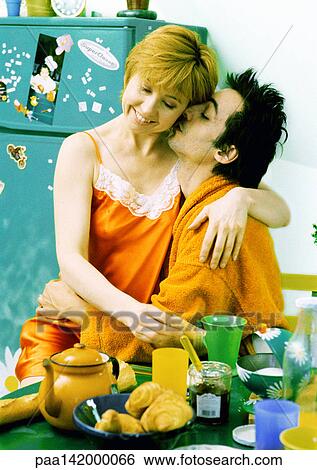 Couple hugging in front of breakfast table, portrait. View Large Photo Image Stock Photograph - Couple hugging in front of breakfast table, portrait.. Fotosearch