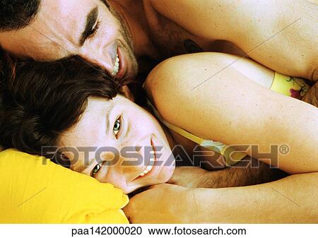 Couple in bed, man lying on woman's back, close-up. View Large Photo Image Stock Image - Couple in bed, man lying on woman's back, close-up.. Fotosearch