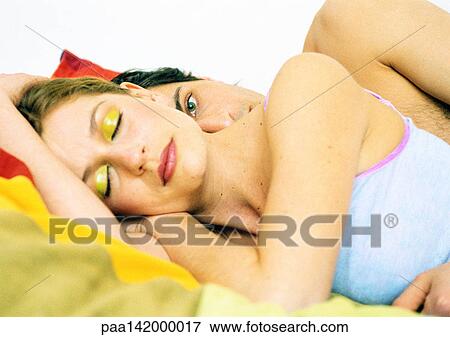 Couple in bed, woman's eyes closed, behind her, man's eyes open View Large Photo Image Stock Photo - Couple in bed, woman's eyes closed, behind her, man's eyes open. Fotosearch