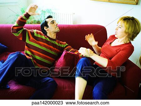 Couple on sofa fighting, man's hand raised, woman flinching. View Large Photo Image Stock Image - Couple on sofa fighting, man's hand raised, woman flinching.. Fotosearch