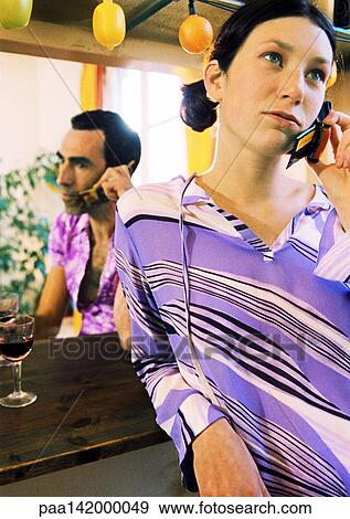 Couple using cell phones, portrait. View Large Photo Image Stock Photo - Couple using cell phones, portrait.. Fotosearch