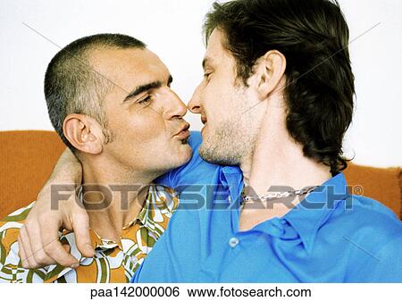 Stock Photograph - Two men about to kiss, portrait.. Fotosearch
