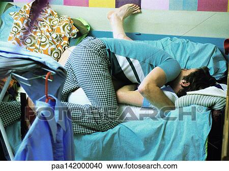 Stock Image - Two men on sofa. Fotosearch