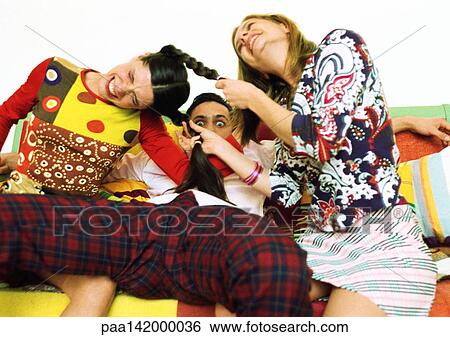 Young woman pulling another woman's hair, man sitting between them. View Large Photo Image Stock Photograph - Young woman pulling another woman's hair, man sitting between them.. Fotosearch