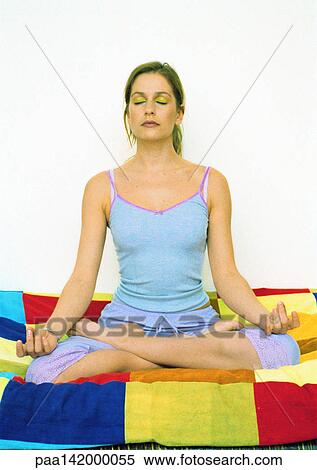 Young woman sitting in Lotus position on bed. View Large Photo Image Stock Photography - Young woman sitting in Lotus position on bed.. Fotosearch