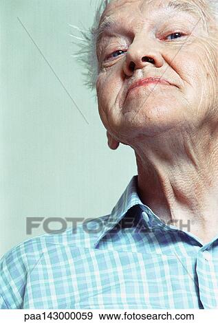 Elderly man looking at camera, low angle view, portrait View Large Photo Image Stock Photo - Elderly man looking at camera, low angle view, portrait. Fotosearch