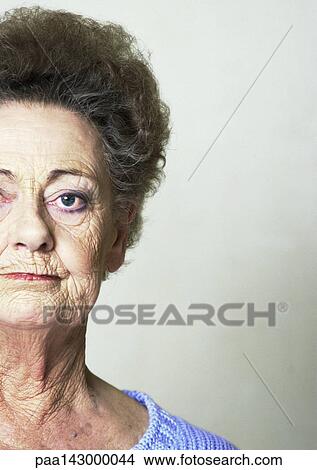 Elderly woman looking at camera, partial view, close-up View Large Photo Image Picture - Elderly woman looking at camera, partial view, close-up. Fotosearch