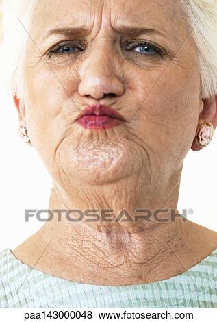 Elderly woman puckering lips and looking at camera, portrait, close-up View Large Photo Image Stock Photo - Elderly woman puckering lips and looking at camera, portrait, close-up. Fotosearch