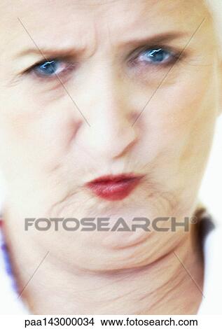 Elderly woman pursing lips and frowning, portrait, close-up, blurred View Large Photo Image Picture - Elderly woman pursing lips and frowning, portrait, close-up, blurred. Fotosearch