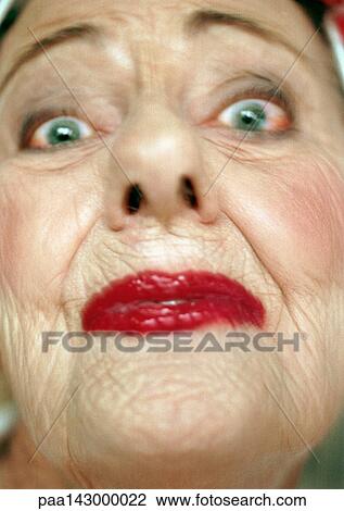 Elderly woman wearing red lipstick looking at camera, portrait, extreme close-up View Large Photo Image Stock Image - Elderly woman wearing red lipstick looking at camera, portrait, extreme close-up. Fotosearch