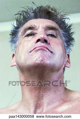 Mature man looking at camera, low angle view, portrait View Large Photo Image Stock Photo - Mature man looking at camera, low angle view, portrait. Fotosearch