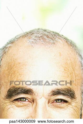 Mature man looking at camera, partial view, close-up View Large Photo Image Stock Photo - Mature man looking at camera, partial view, close-up. Fotosearch