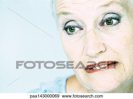 Mature woman, biting lip and looking away, close-up, portrait View Large Photo Image Stock Photo - Mature woman, biting lip and looking away, close-up, portrait. Fotosearch