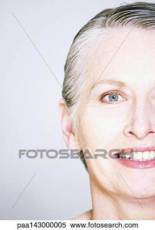 Mature woman looking at camera, close-up, partial view View Large Photo Image Stock Photography - Mature woman looking at camera, close-up, partial view. Fotosearch