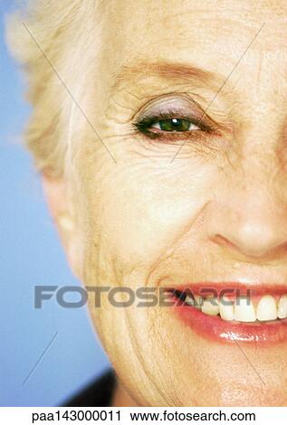 Mature woman smiling at camera, close-up, partial view View Large Photo Image Stock Image - Mature woman smiling at camera, close-up, partial view. Fotosearch