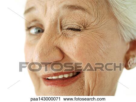 Senior woman winking at camera, portrait, close-up View Large Photo Image Stock Image - Senior woman winking at camera, portrait, close-up. Fotosearch
