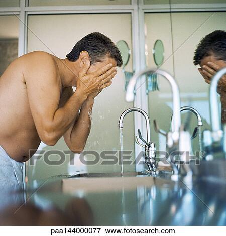 Man rinsing face, side view View Large Photo Image Stock Photo - Man rinsing face, side view. Fotosearch