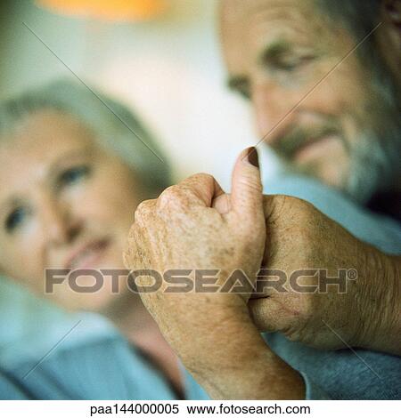 Mature couple holding hands, focus on hands View Large Photo Image Stock Photography - Mature couple holding hands, focus on hands. Fotosearch