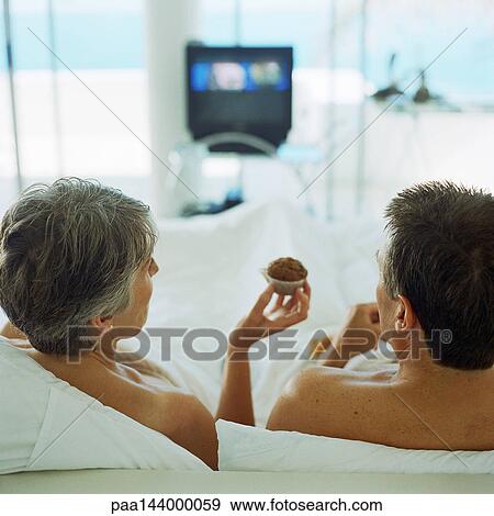 Mature couple in bed, woman holding muffin, rear view View Large Photo Image Stock Photo - Mature couple in bed, woman holding muffin, rear view. Fotosearch