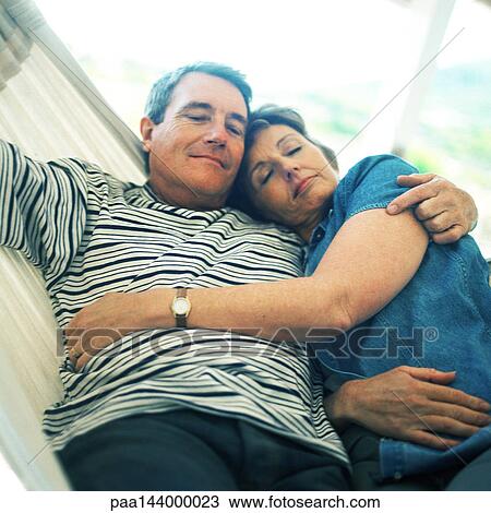 Mature couple lying in hammock View Large Photo Image Stock Image - Mature couple lying in hammock. Fotosearch